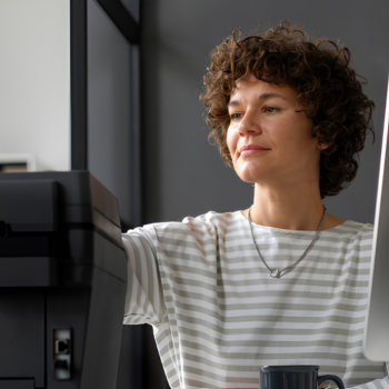 Women loading paper in a leaser printer 