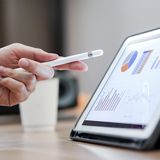 Hand with pen pointing at tablet
