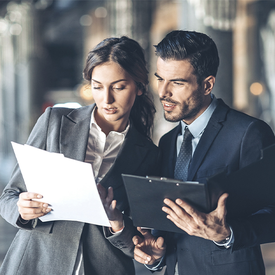 Man and woman looking at paperwork.