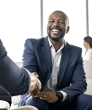Man smiling while shaking hands