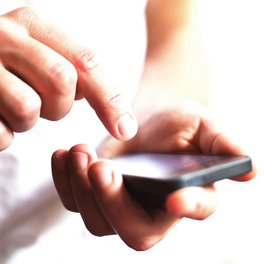 close up of hand holding a smartphone