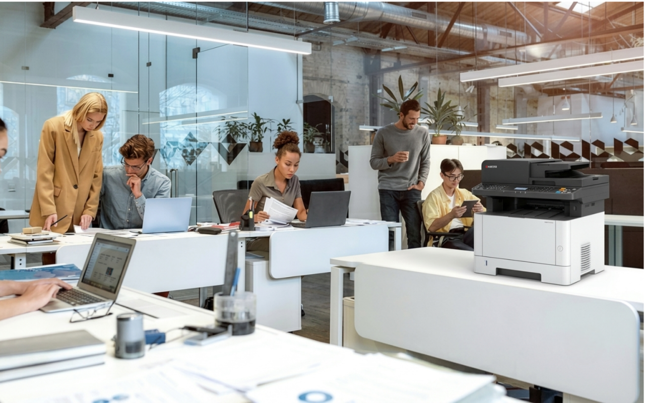 Kyocera multifunction printer featured on a desk in a modern office environment.