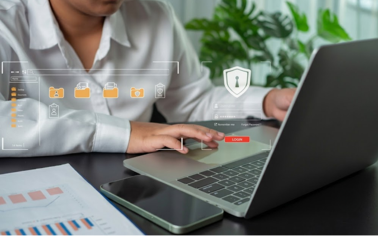 A person using a laptop with digital overlays of a secure login screen, a shield icon with a keyhole, and protected document folders.