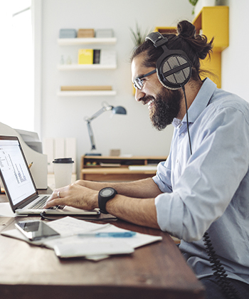 man smiling looking at laptop