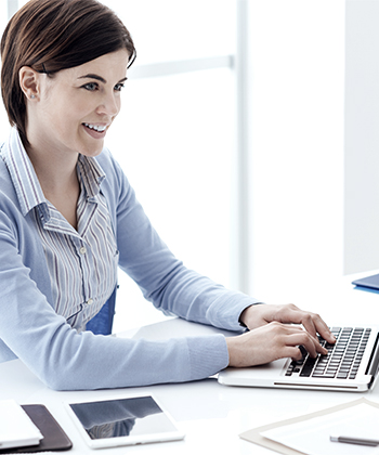 Woman smiling with a laptop