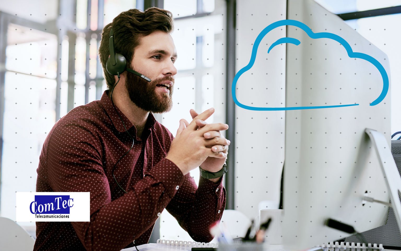 Man with headset in front of computer monitor