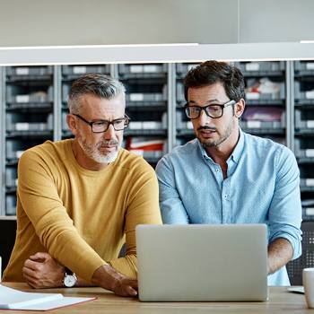 IT Two men looking at laptop